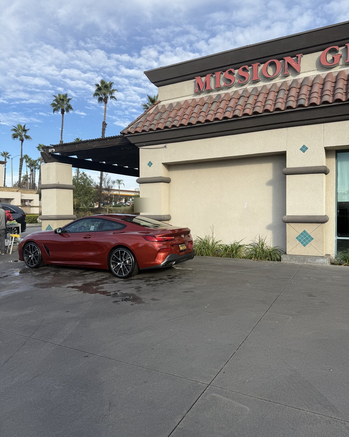 Sunset orange BMW 8 Series coupe at Mission Grove Car Wash