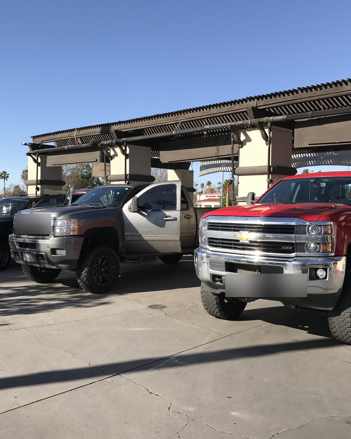 Lifted trucks at Mission Grove Car Wash — we wash everything from work trucks to luxury cars