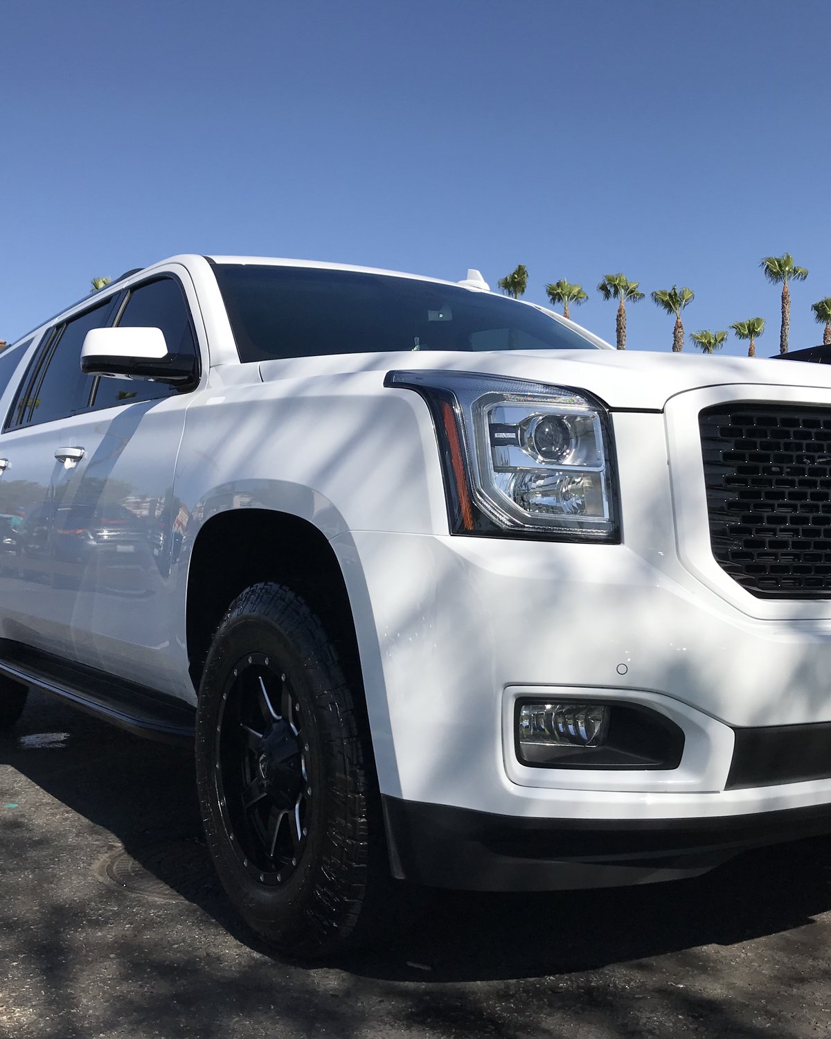 White GMC Yukon Denali at Mission Grove Car Wash in Riverside